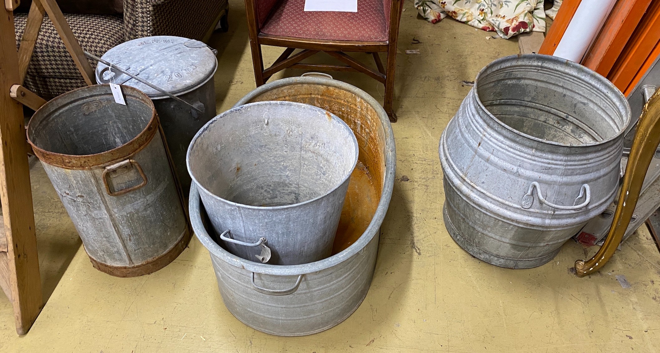 Seven galvanised containers and two tin measures, largest height 55cm